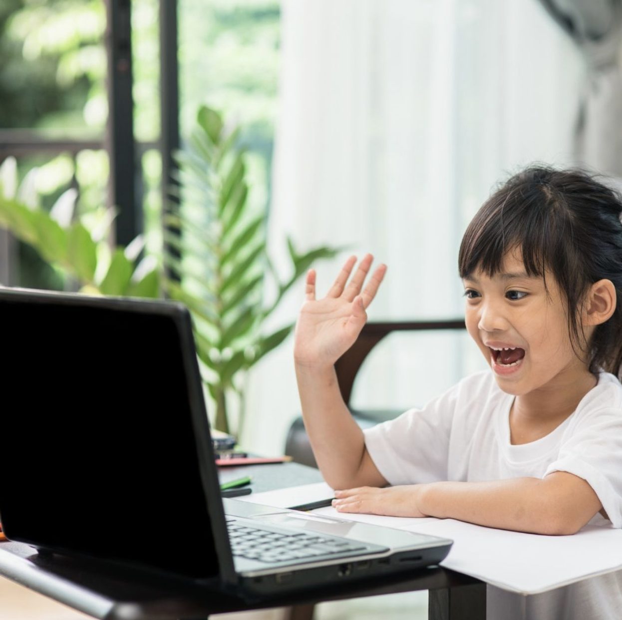 Child learning with parental guidance at study desk