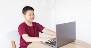 Boy learning on laptop