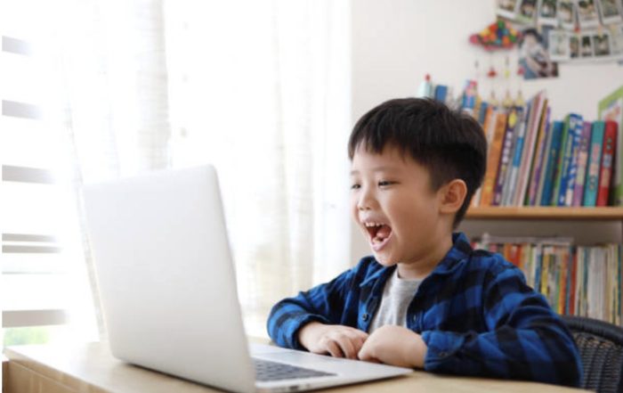 Child learning Chinese online using laptop at home