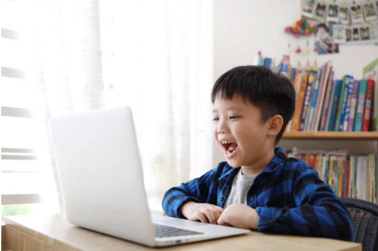 Child learning Chinese online using laptop at home