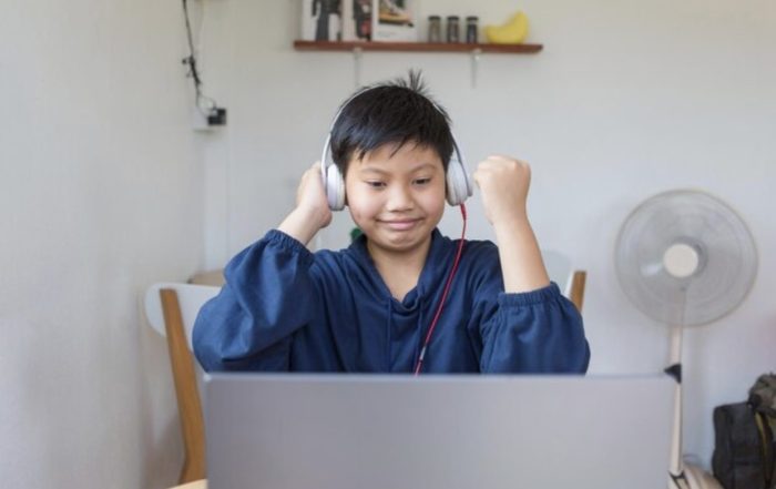 Child celebrating progress during virtual Chinese lesson
